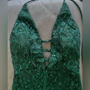 Dark green sequence prom gown. Form fitting and soft material on the inside.